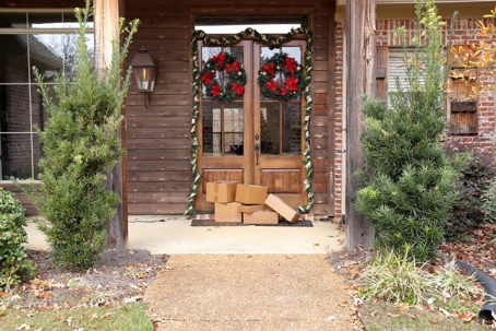 Boxes and packages next to front door during holiday christmas season